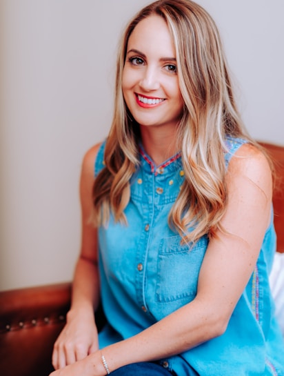 smiling girl in blue sleeveless dress