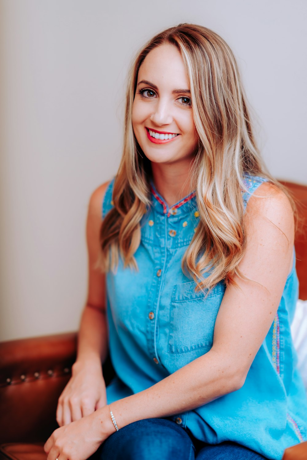 smiling girl in blue sleeveless dress