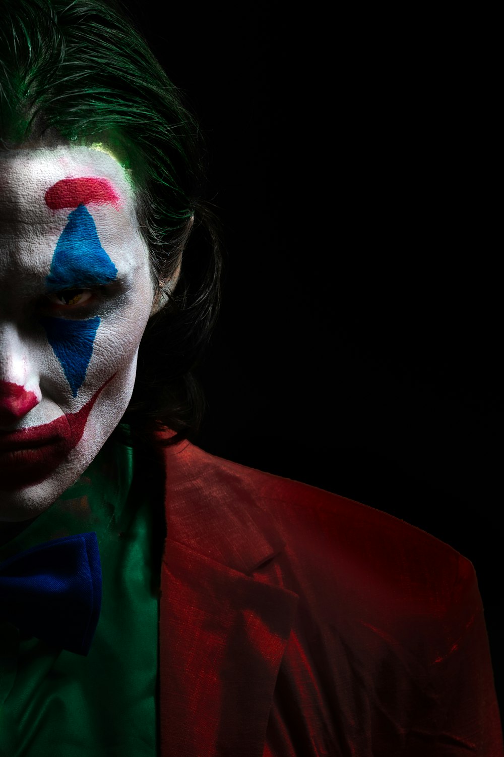 woman with blue green and red face paint