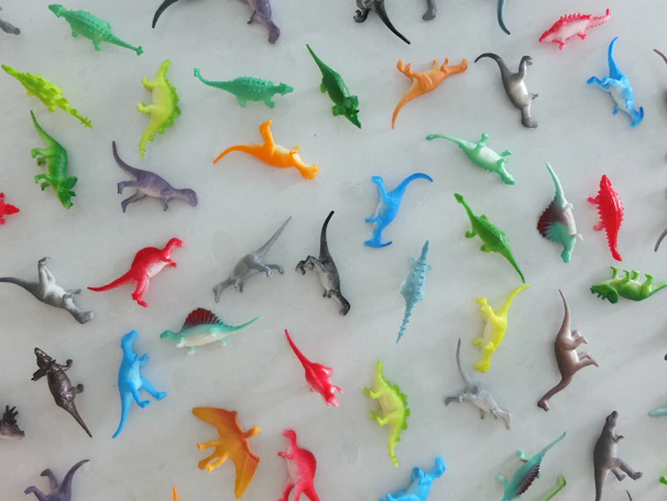 A spread showing various dinosaur species illustrations from the coloring book.