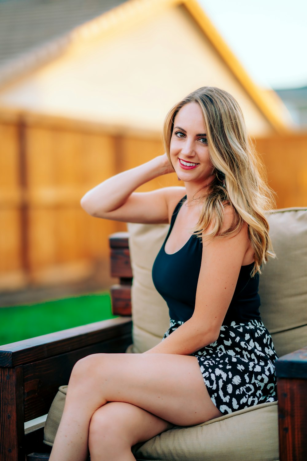 woman in black tank top sitting on brown wooden bench