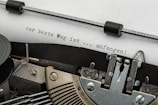black and gray typewriter on white printer paper