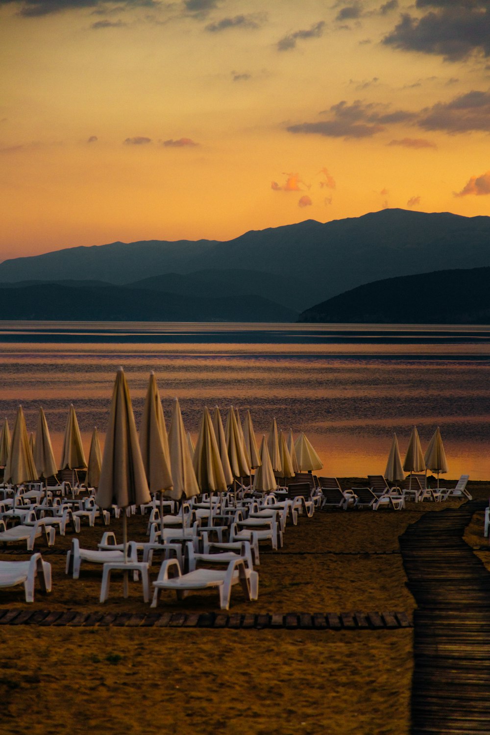 white chairs on beach during sunset