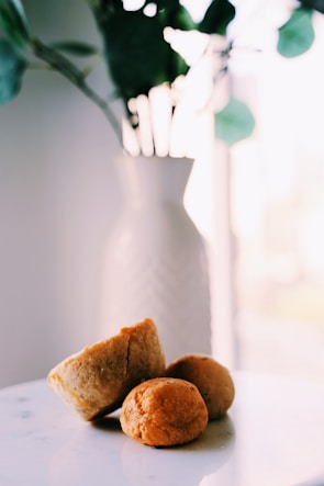 Four molen pastries arranged neatly on a white ceramic plate with a soft background