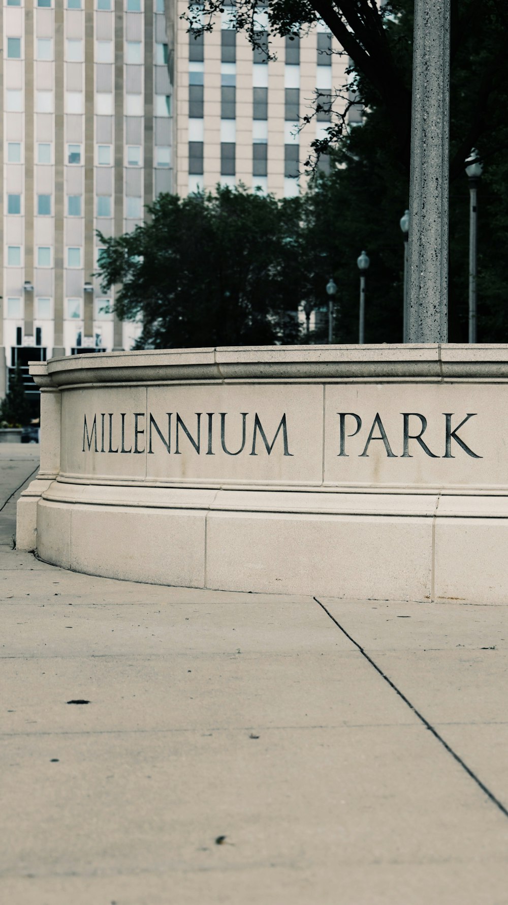 a sign that says millennium park in front of a building