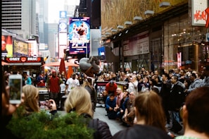 A candid shot of a lively street performer entertaining a joyful crowd on a sunny afternoon.