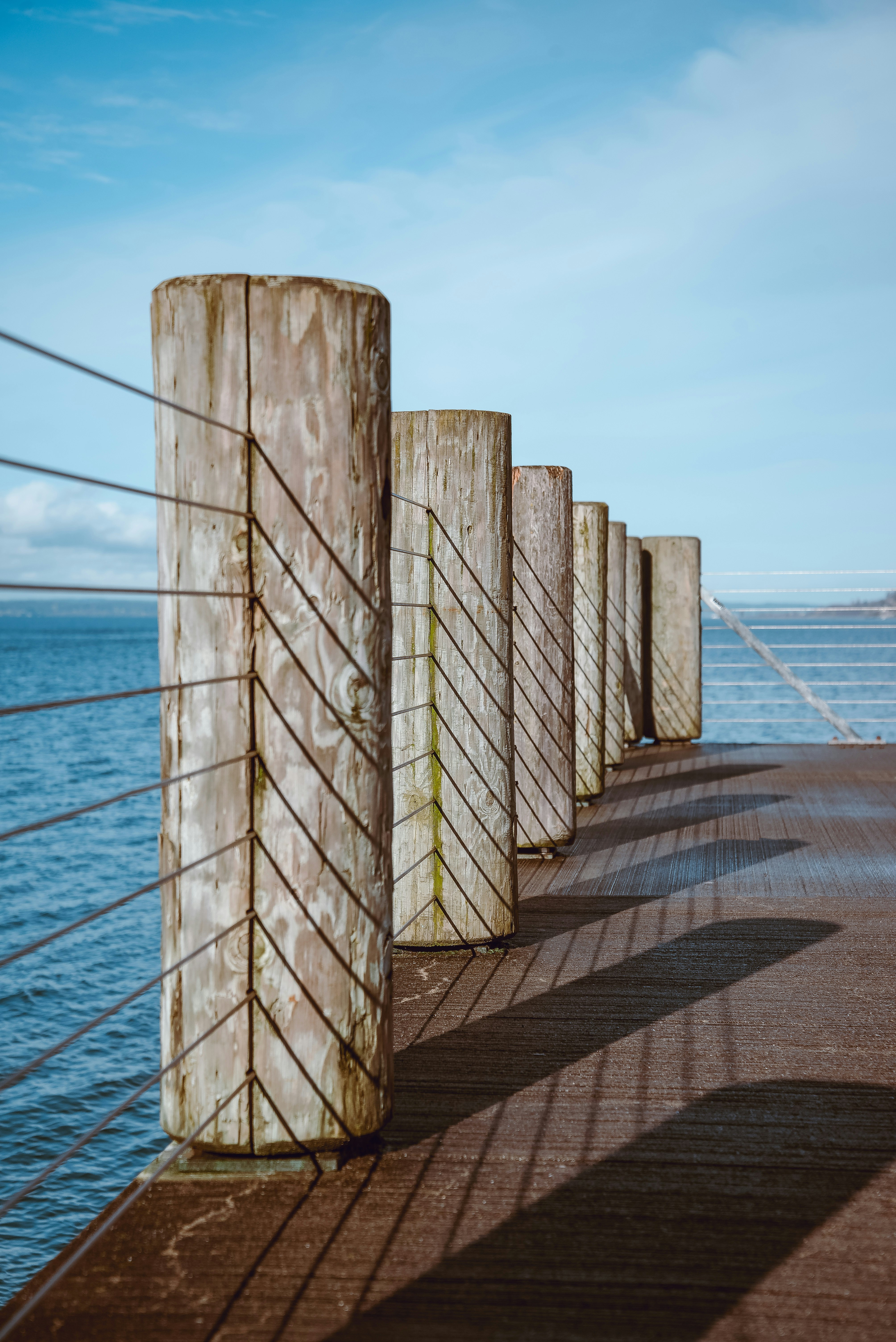 brown wooden fence near body of water during daytime