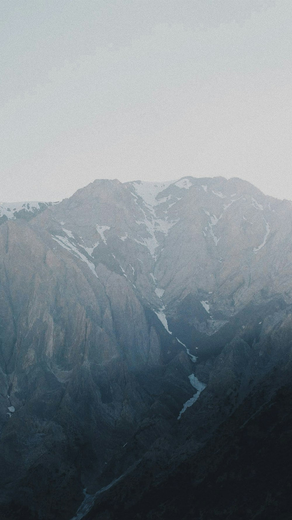 gray rocky mountains under white sky during daytime