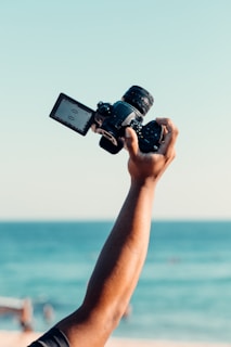 person holding black dslr camera