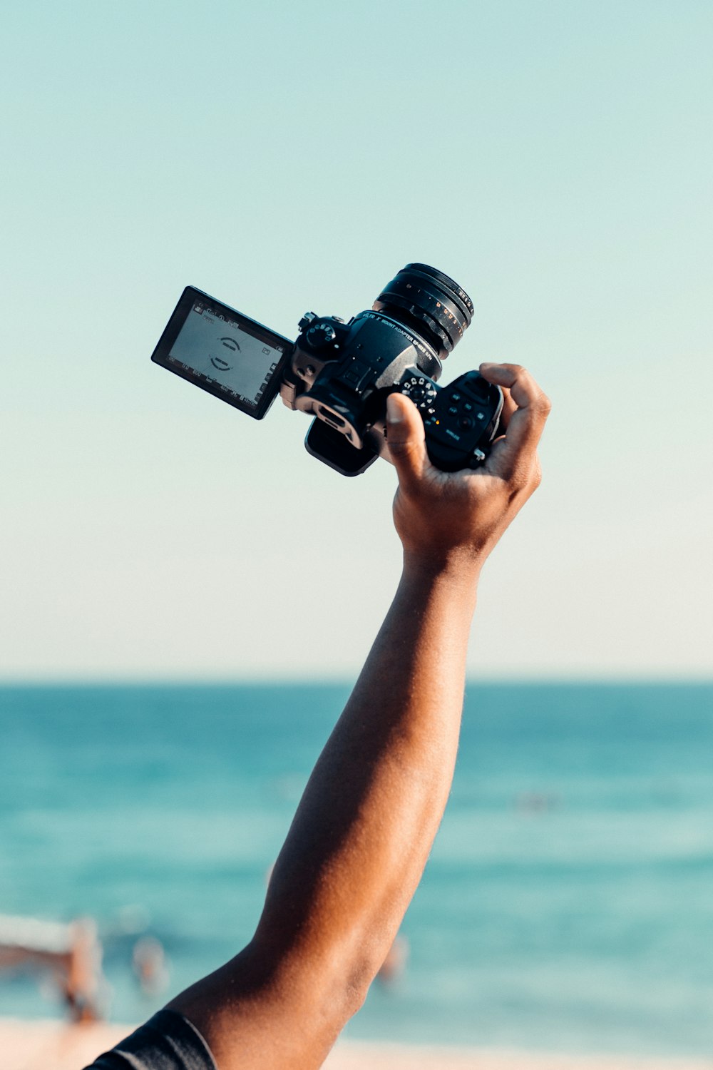 person holding black dslr camera