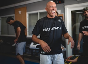 man in black crew neck t-shirt and white shorts standing