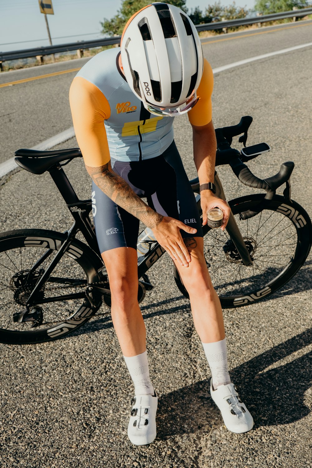 man in yellow t-shirt and black shorts riding black bicycle