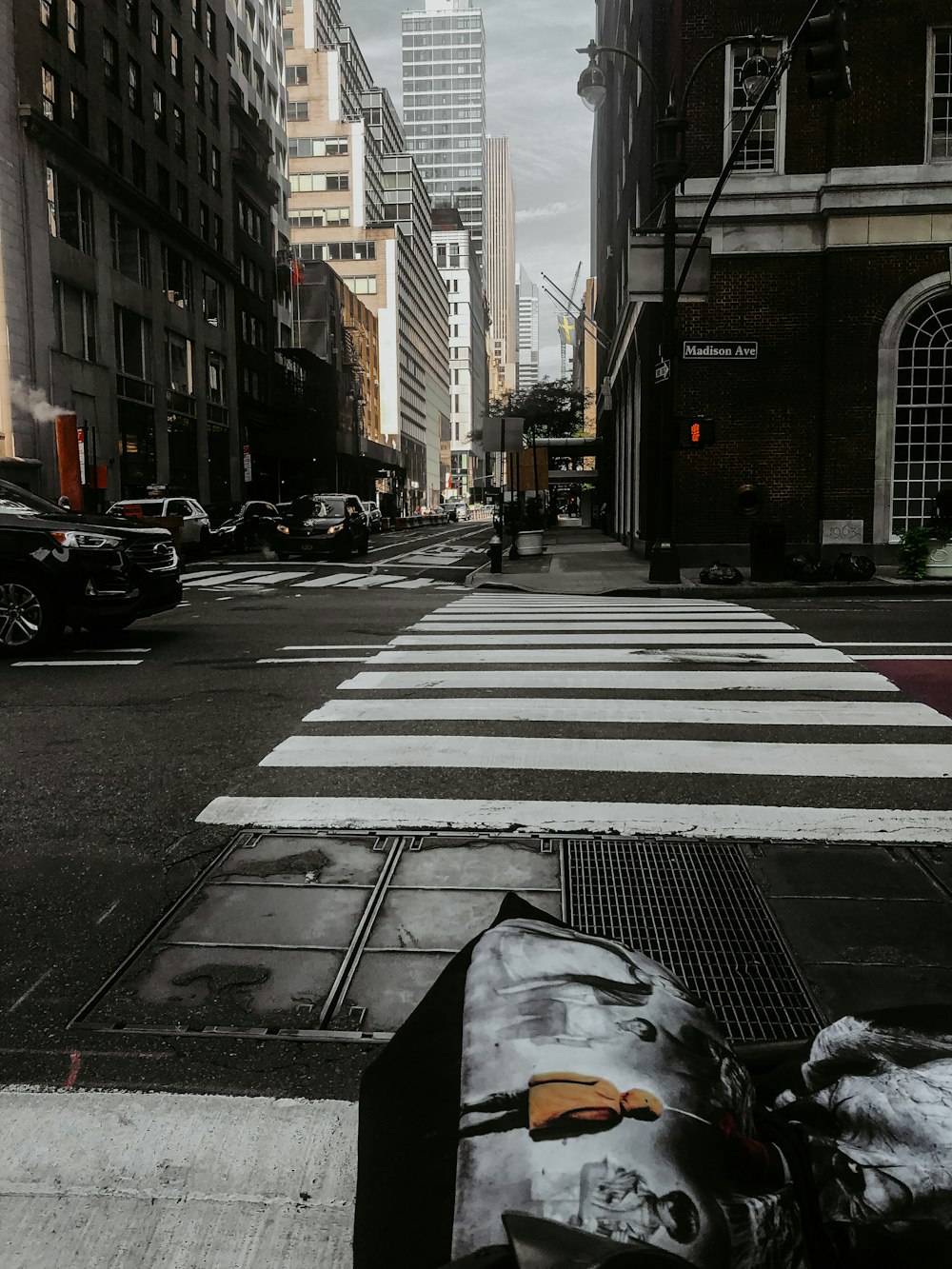 cars parked on sidewalk near buildings during daytime