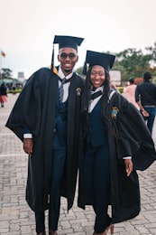 Black doctoral graduate celebrating at graduation ceremony