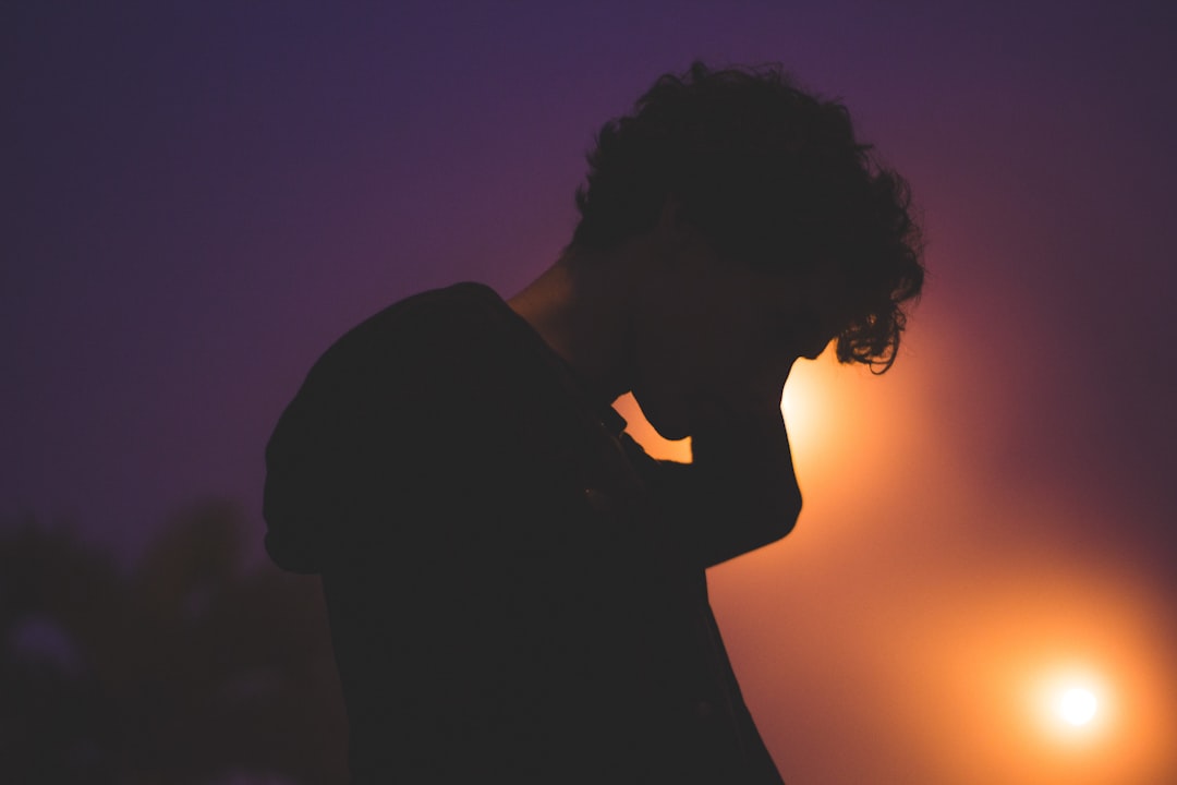 silhouette of man with light on his face,