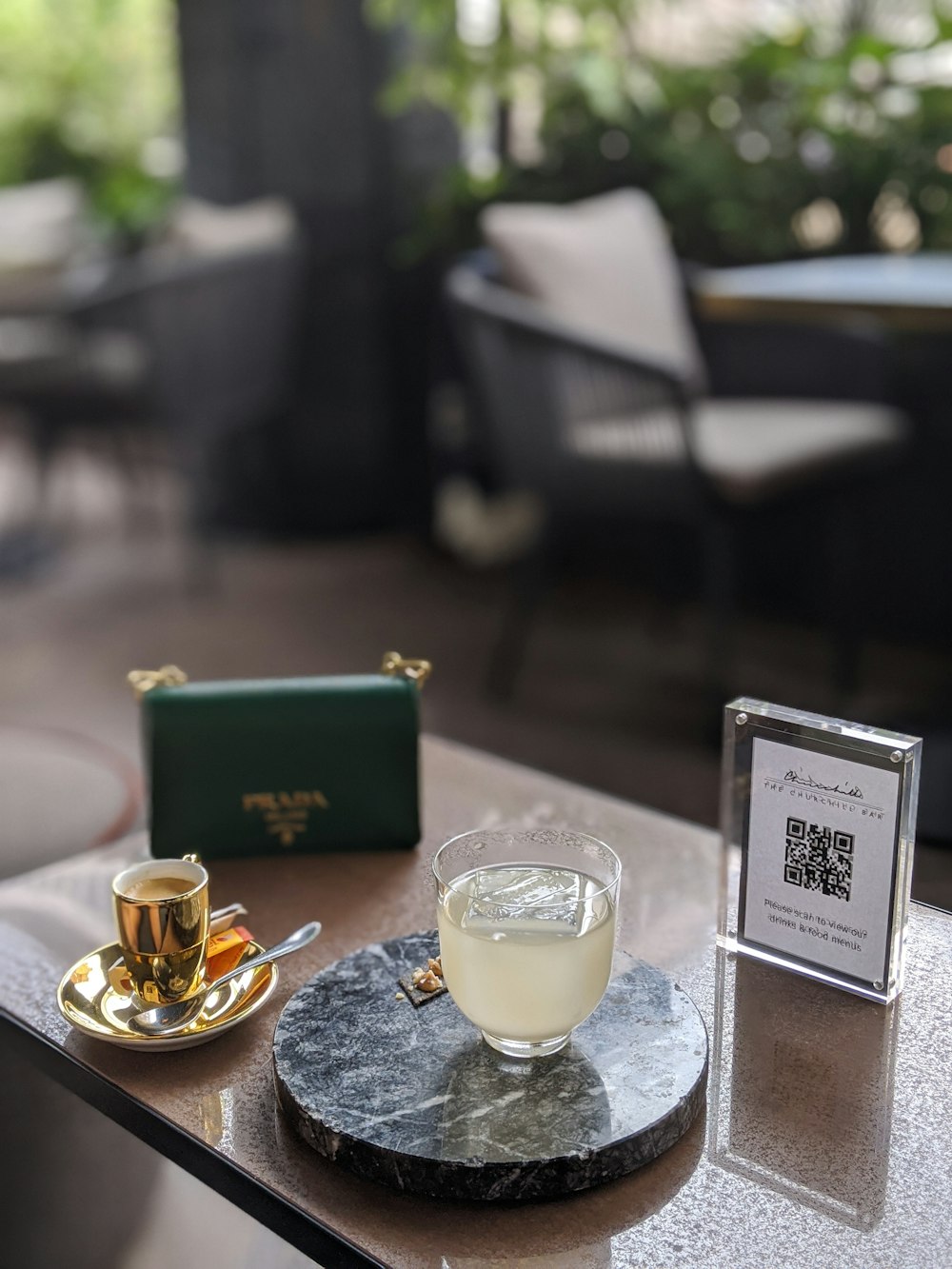 gold ring on white book beside clear drinking glass