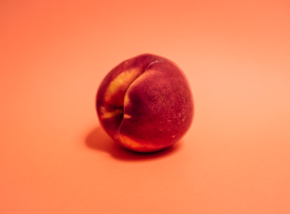 red apple on white table
