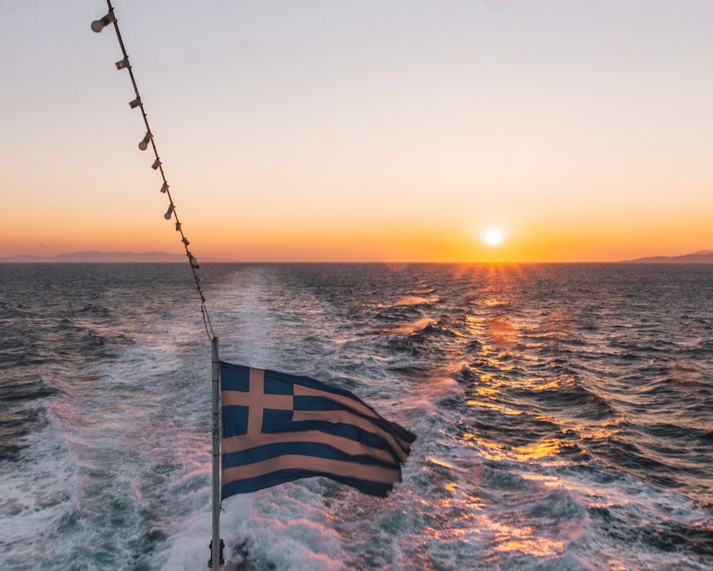 flag of us a on pole during sunset