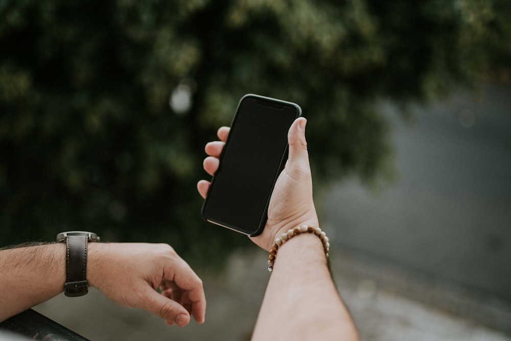 person holding black iphone 5