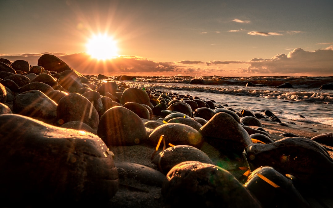 gray rocks on seashore during sunset