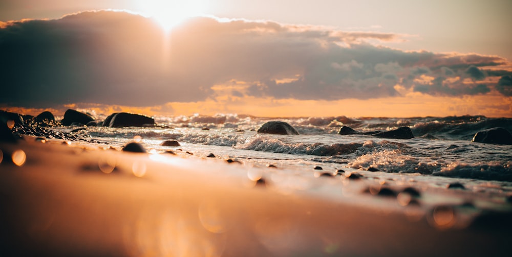 rocky shore under white clouds during daytime