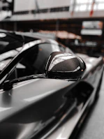 An OEM buyer evaluating a car rearview mirror system in a modern automotive factory setting