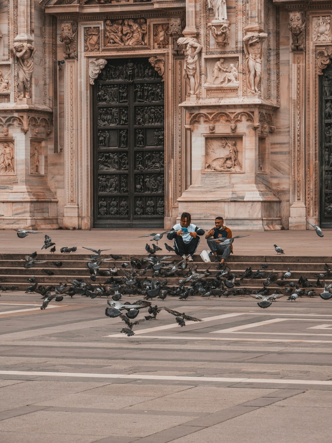 people sitting on bench in front of building