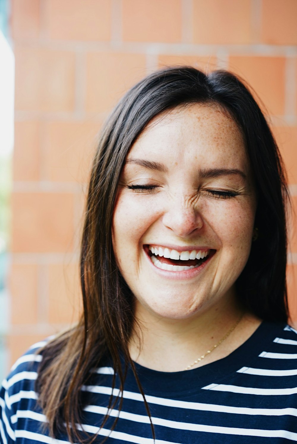 woman in black and white crew neck shirt smiling