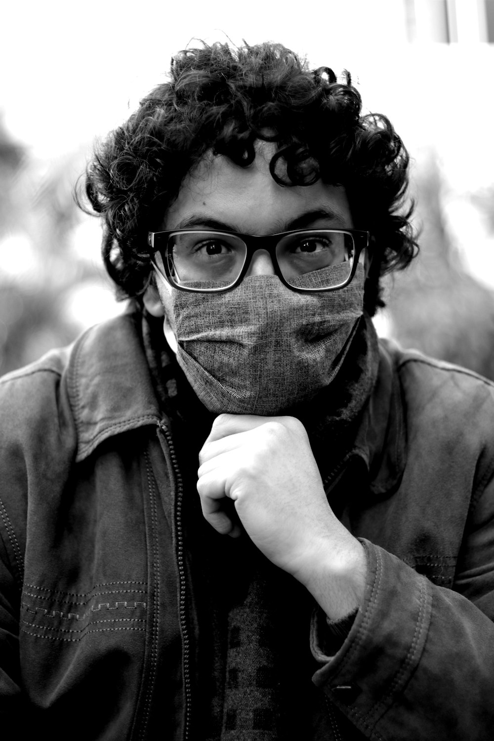 grayscale photo of man wearing black framed eyeglasses