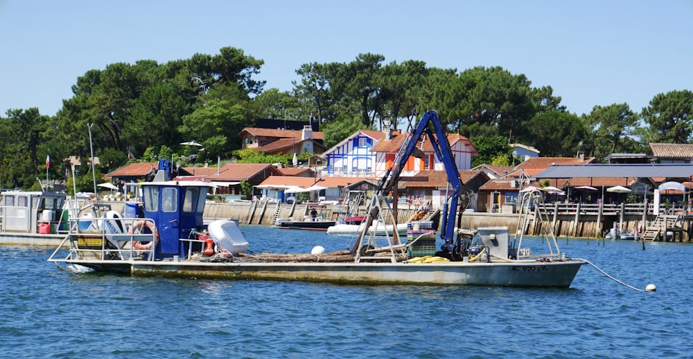 white and blue boat on body of water during daytime