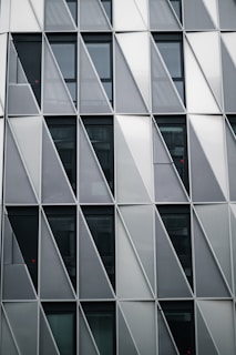 Modern building facade featuring a geometric pattern of curtain walls.