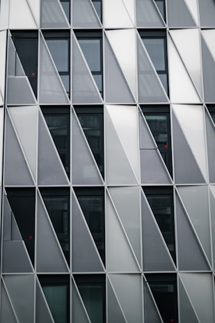 Modern building facade featuring a geometric pattern of curtain walls.