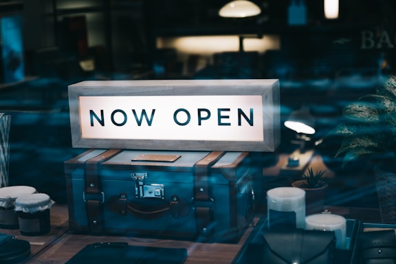 there is a sign that says now open