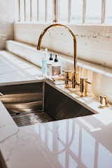 stainless steel faucet with white plastic bottle