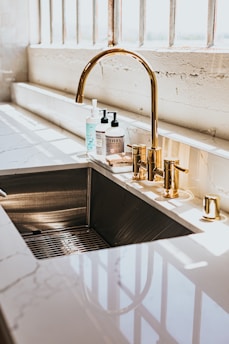 stainless steel faucet with white plastic bottle