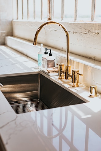 stainless steel faucet with white plastic bottle