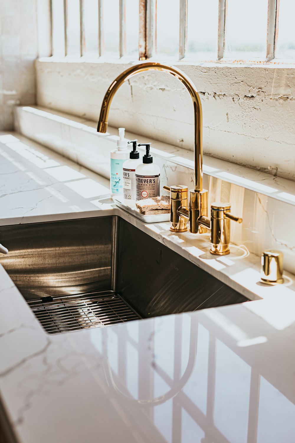 stainless steel faucet with white plastic bottle