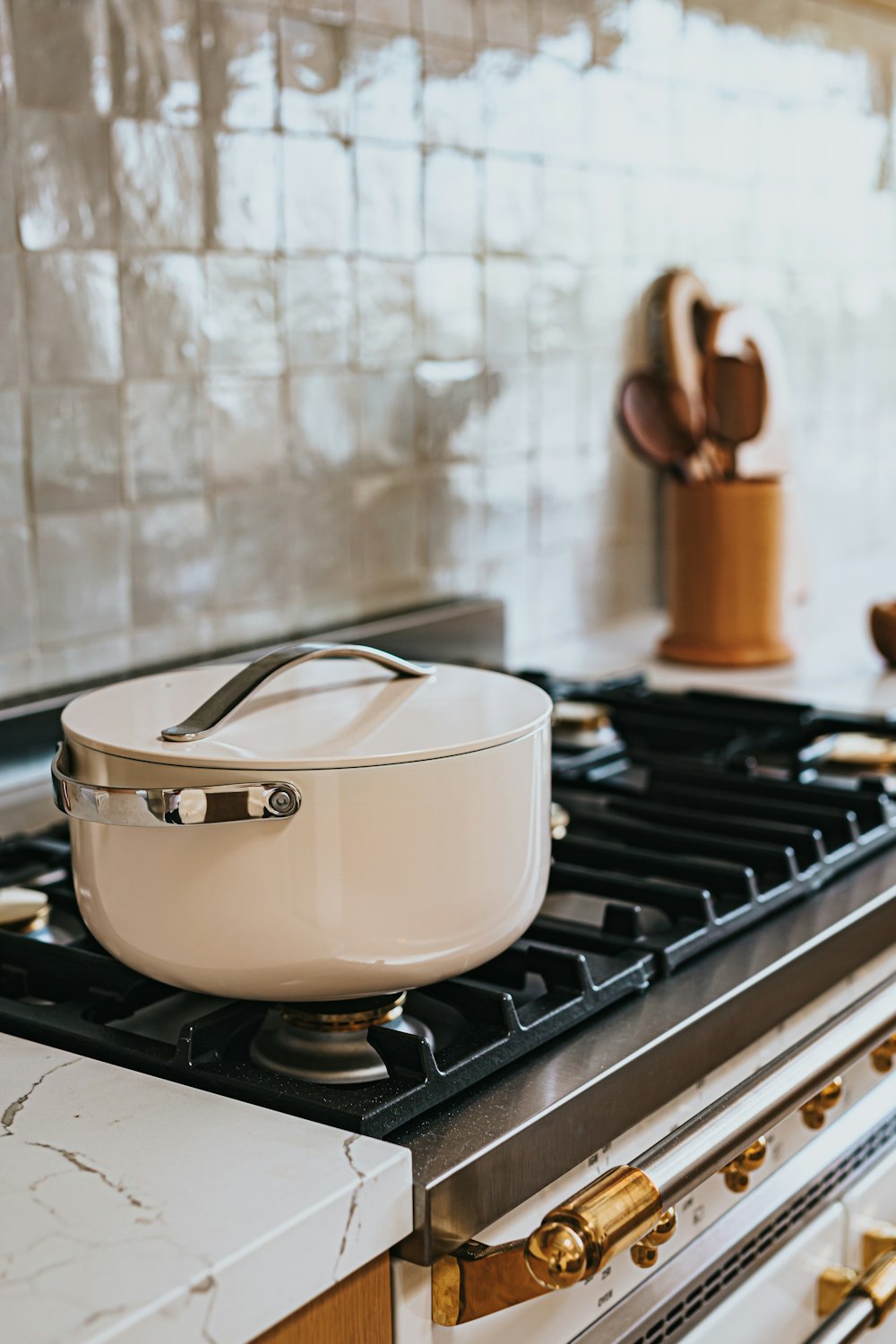 white and brown ceramic cooking pot on stove