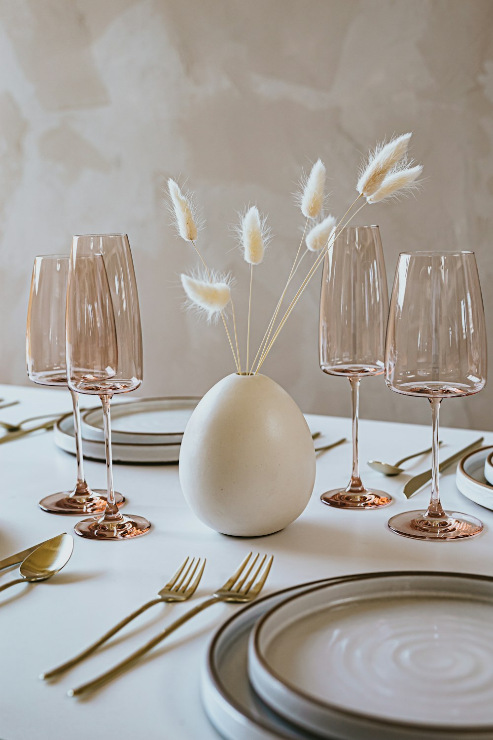 white ceramic bowl with gold spoon and fork