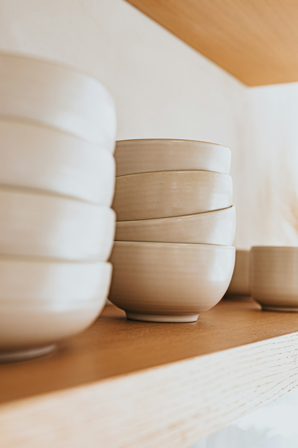 white ceramic bowls on brown wooden table