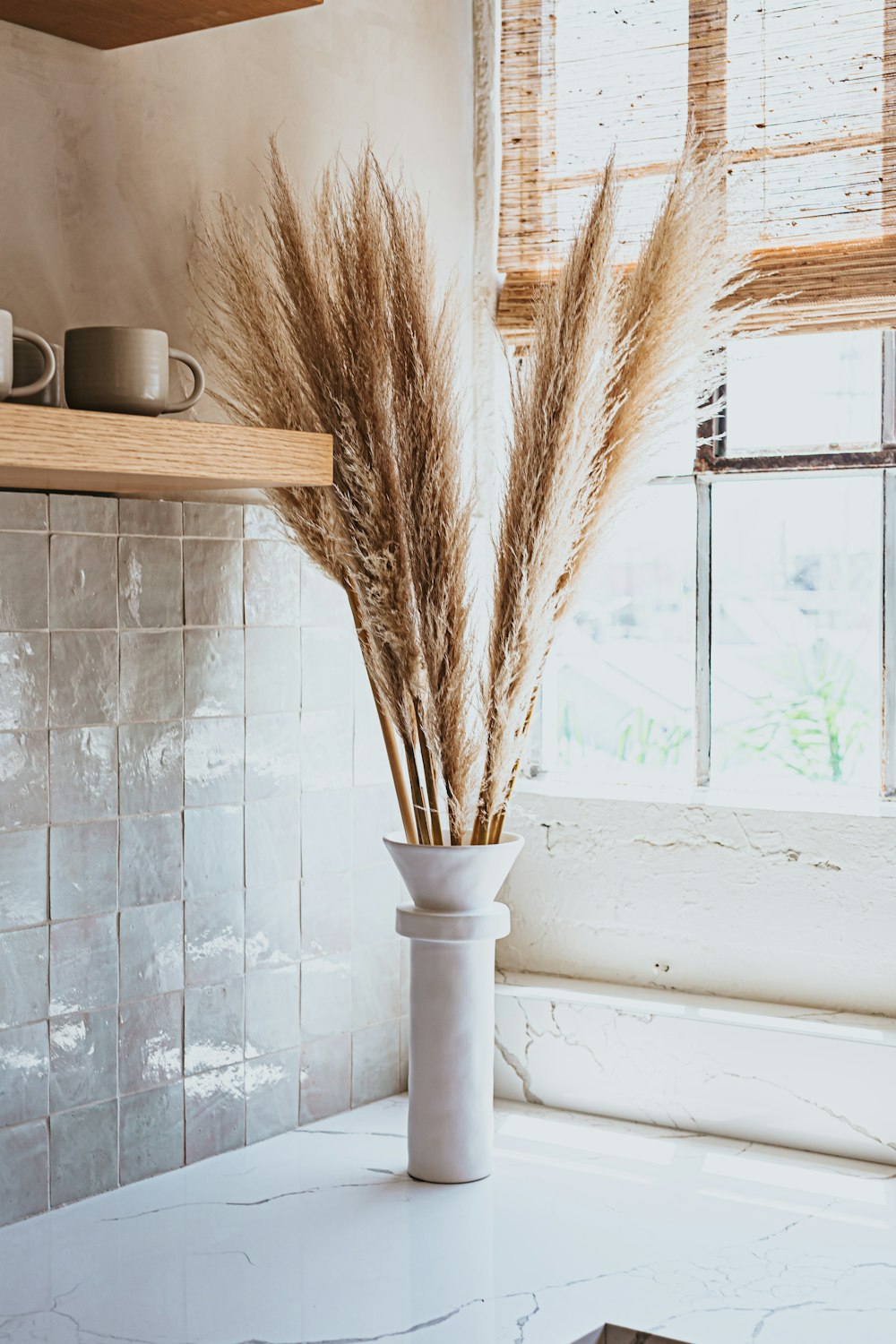 brown wheat on white ceramic vase