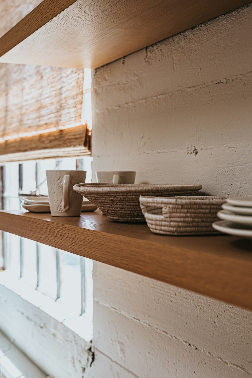white ceramic bowl on brown wooden shelf