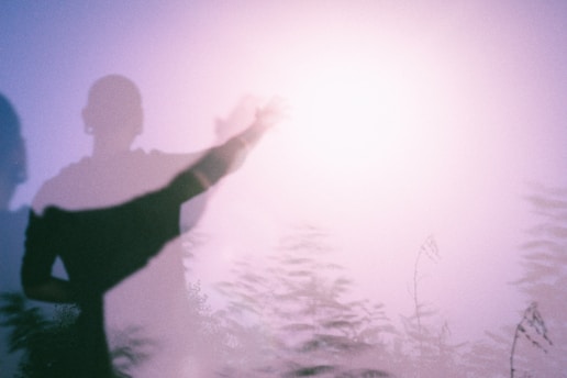 Man standing half in shadow, symbolizing hidden emotional struggles and masculinity as performance