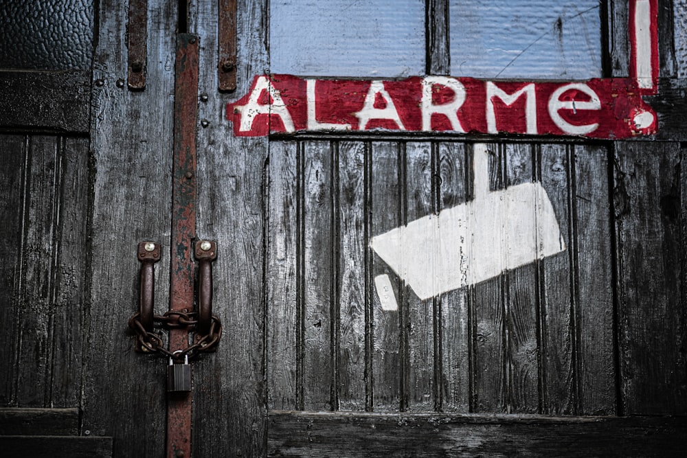 red and white wooden door with love print