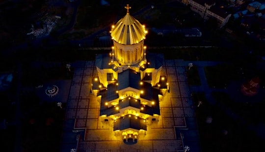 gold and black building with lights during night time in Tbilisi Georgia