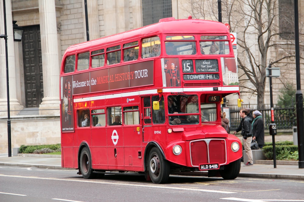 red double decker bus on road during daytime