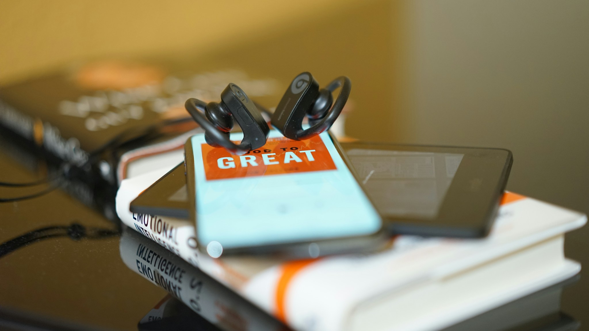 white and red book on brown wooden table; Photo by Distingué CiDDiQi on Unsplash 