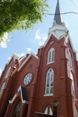 Color photograph of the church's new brick sanctuary completed in 1955 with stained glass windows.