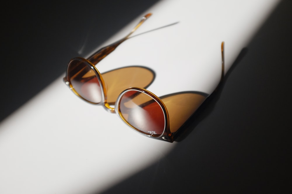 brown framed eyeglasses on white table