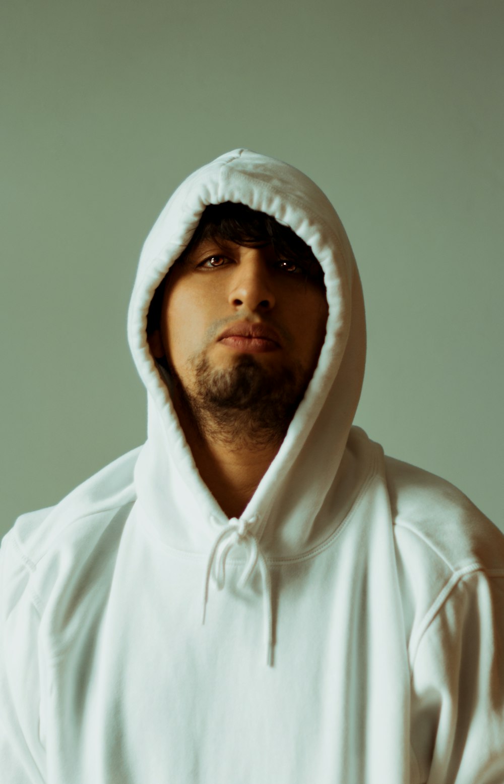 man in white hoodie taking selfie